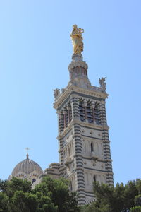 Low angle view of building against blue sky