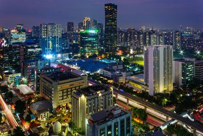 High angle view of illuminated buildings in city at night