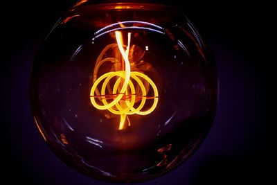 Close-up of illuminated light bulb