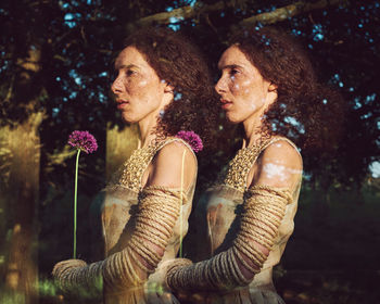 Multiple image of woman holding flower against tree