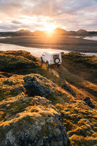 4x4 truck looks out over sunrise landscape in iceland