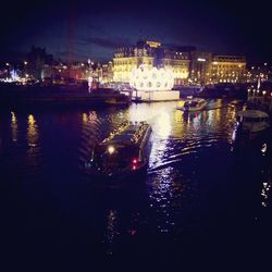 Boats in river with city in background