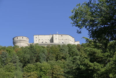 Low angle view of building against clear blue sky