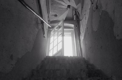 Low angle view of narrow corridor along wall