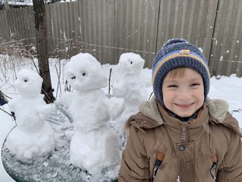Portrait of boy in snow during winter