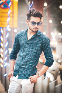 Young man wearing sunglasses standing outdoors