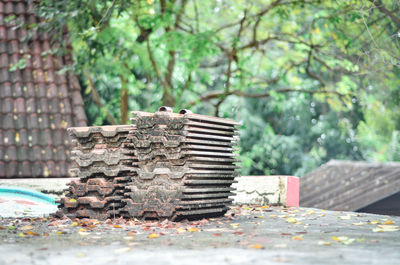 Close-up of stone stack on table against trees