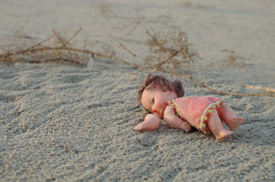 Cute girl lying on sand at beach