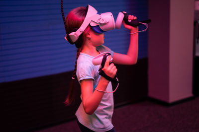 Vr game and virtual reality. kid girl gamer eight years old fun playing on simulation video game