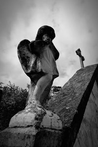 Low angle view of angel statue against sky