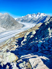 Scenic view of snowcapped mountains against clear blue sky