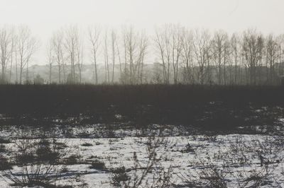 Scenic view of lake against sky during winter