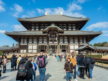 Group of people outside temple against building