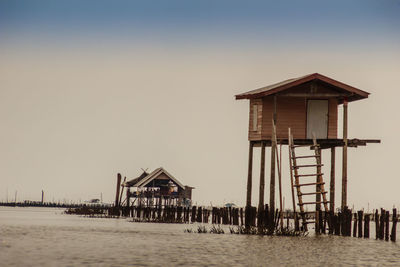 Lifeguard hut on beach against clear sky