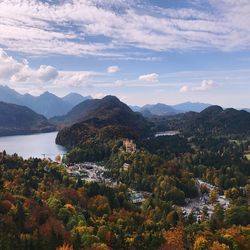 Scenic view of river and mountains against sky