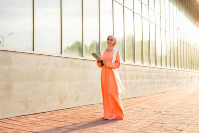 Woman standing against wall