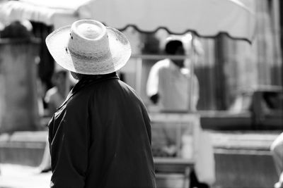 Rear view of woman looking at camera