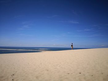 Scenic view of beach against blue sky