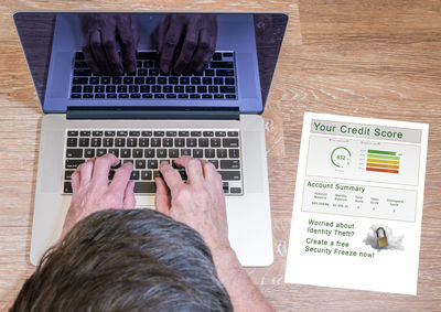 Directly above view of man using laptop at table