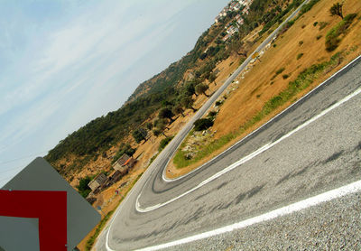 High angle view of vehicles on road by mountain against sky