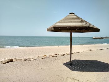 Lifeguard hut on beach against clear sky