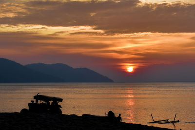 Scenic view of sea against orange sky