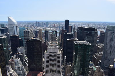 Aerial view of buildings in city against clear sky