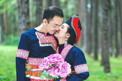 Young couple kissing on flower