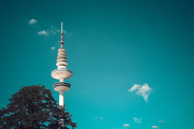 Low angle view of communications tower against sky