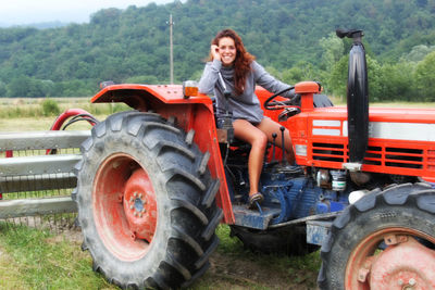 Portrait of smiling young woman on dirt road