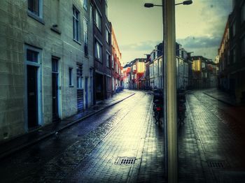 Empty road with buildings in background