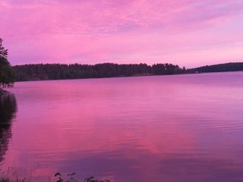 Scenic view of lake against sky at sunset