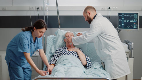 Doctors examining patients in clinic