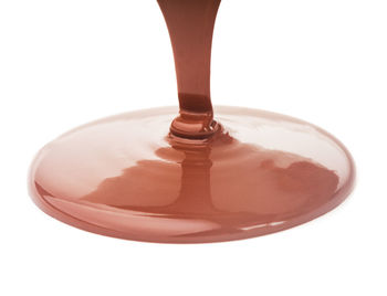 Close-up of drink in glass against white background