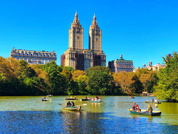View of boats in river with buildings in background