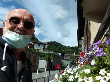 Portrait of man on flowering plant