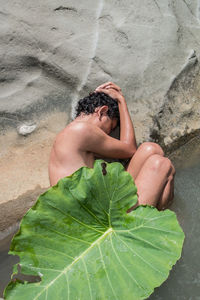 High angle view of man lying on beach