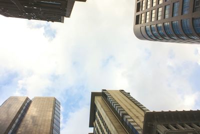 Low angle view of buildings against cloudy sky