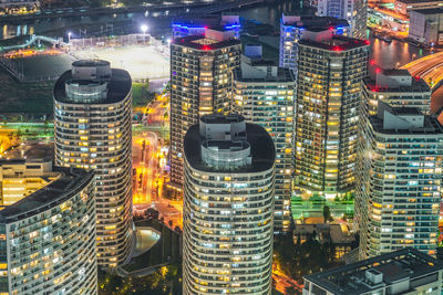 High angle view of illuminated buildings in city at night