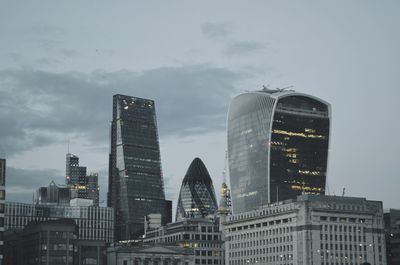 Low angle view of london skyline buildings against sky at dusk