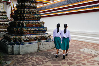 FULL LENGTH REAR VIEW OF PEOPLE WALKING OUTSIDE TEMPLE