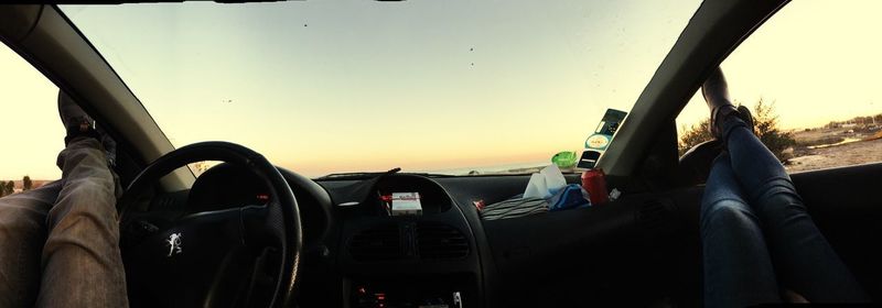 Panoramic shot of car against sky during sunset