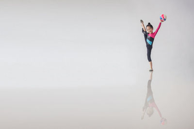 Woman dancing against white background