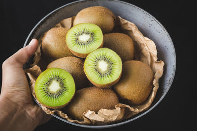 High angle view of hand holding fruits