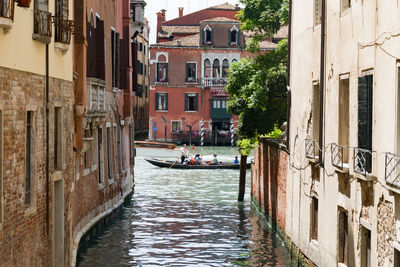 People on gondola sailing in canal