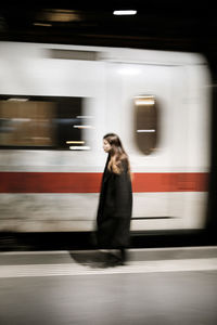 Full length of woman walking in train