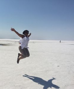 Full length of a man jumping on beach