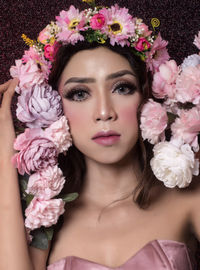 Close-up portrait of woman with pink flowers