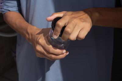 Midsection of man holding water