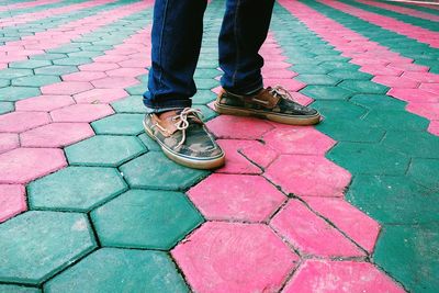 Low section of man standing on cobblestone